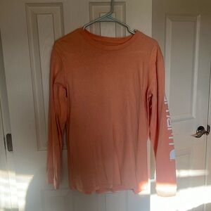Vibrant peach colored carhartt long sleeve